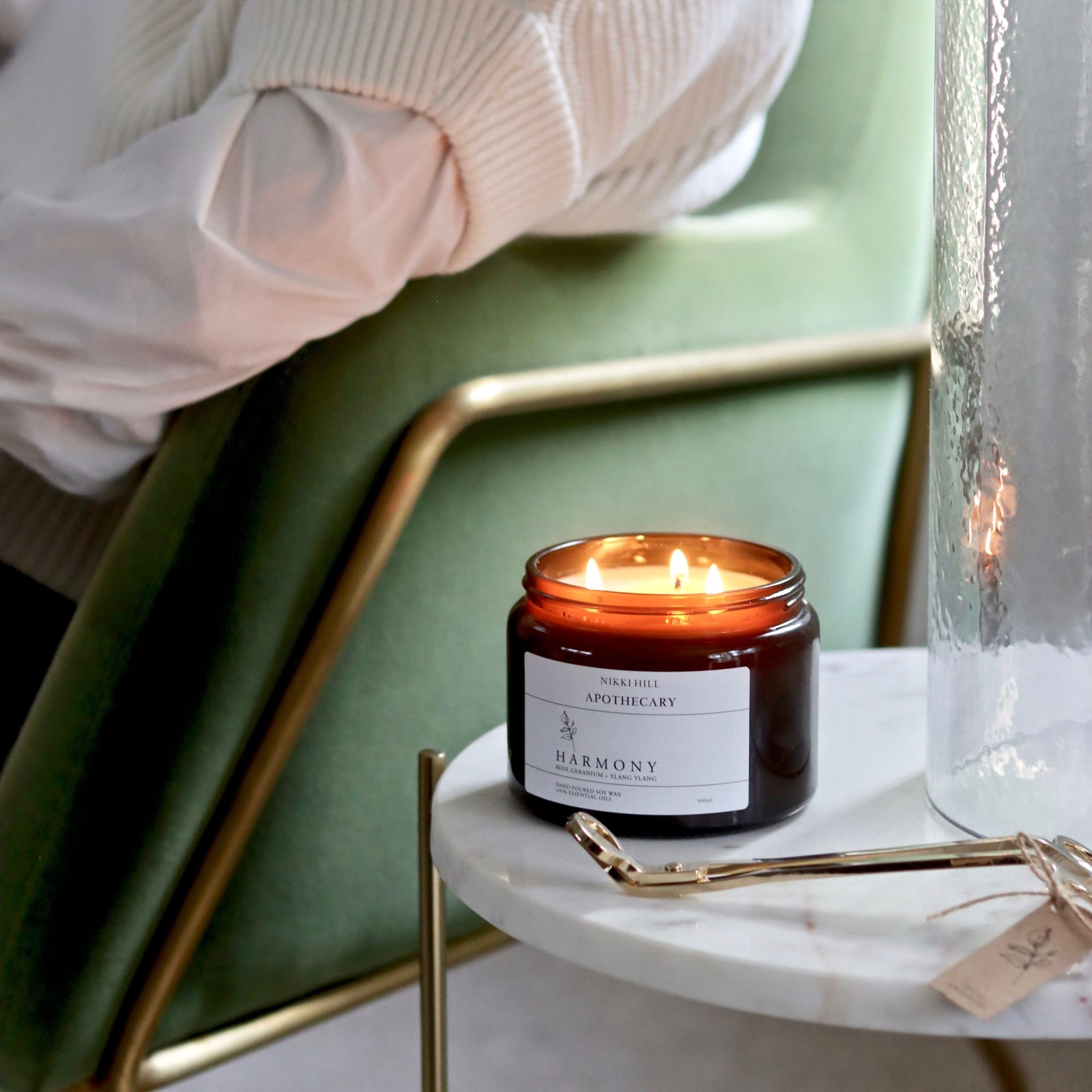Harmony essential oil candle by nikki hill apothecary in a amber jar